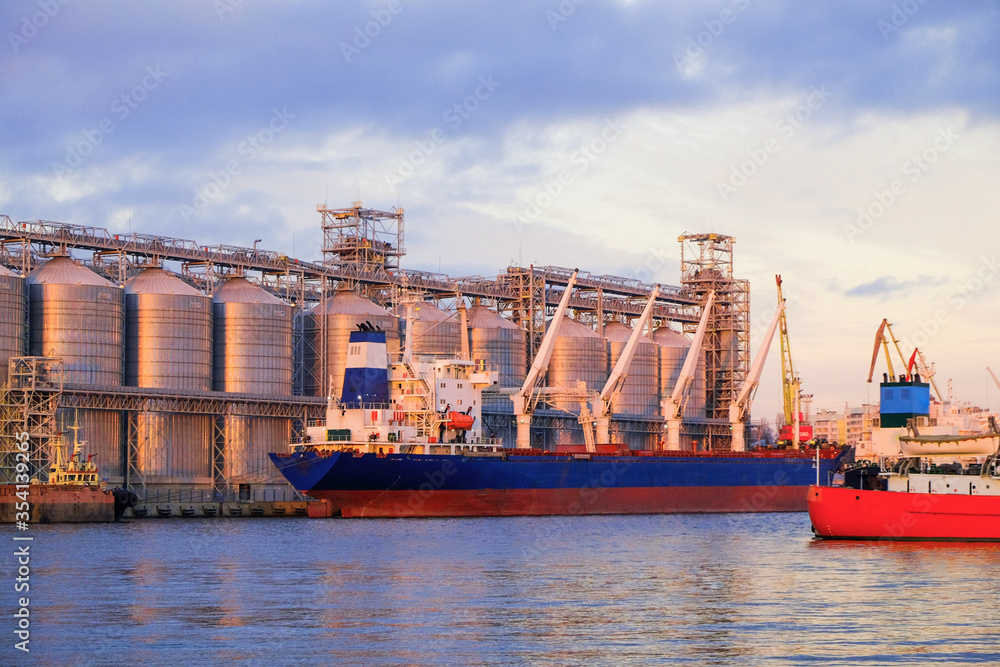 Wall mural bulk carrier ship in river port. dry cargo grain elevator trade. agrarian maritime facility. cargo s