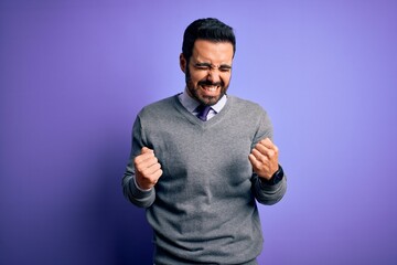 Handsome businessman with beard wearing casual tie standing over purple background very happy and excited doing winner gesture with arms raised, smiling and screaming for success. Celebration concept.