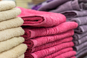 Stack of terry towels on the shelf, close up.