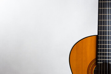 Acoustic guitar placed on the right
 side in landscape format on a light background