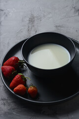Strawberry in the bowl, black background