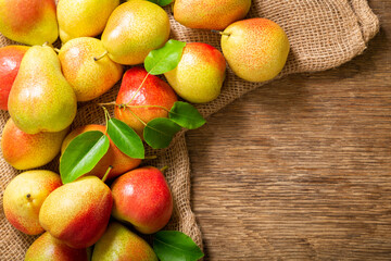 fresh pears on a wooden table, top view