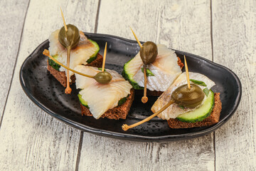 Herring fillet canape with caperberry