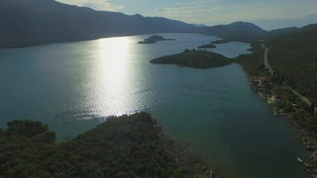 Aerial view of idyllic ocean against sky on sunny day, drone is flying forward - Ston, Croatia