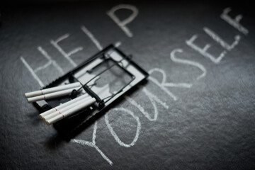 The meanness of cigarettes, the harm of smoking, habits concept. Inscription Help yourself on the...