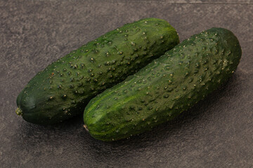 Green fresh cucumbers over background