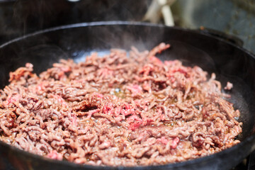 Roasting minced meat in a pan.