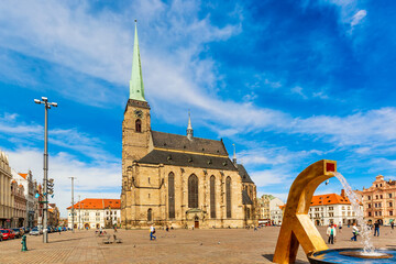 St. Bartholomew's Cathedral in the main square of Plzen with a fountain on the foreground against...