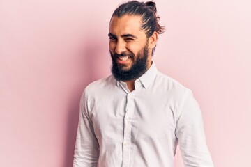 Young arab man wearing casual clothes winking looking at the camera with sexy expression, cheerful and happy face.
