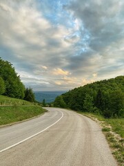 Fototapeta na wymiar Landscape photography of road with dramatic cloud in background