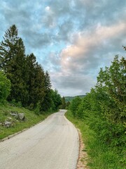 Fototapeta na wymiar Landscape photography of road with dramatic cloud in background