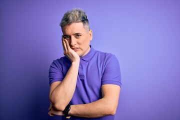 Young handsome modern man wearing casual purple t-shirt over isolated background thinking looking tired and bored with depression problems with crossed arms.