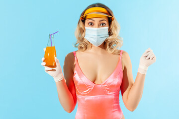Safe drink with straw! Surprised woman in swimsuit looking amazed in hygienic mask and gloves, holding cocktail with disposable straw, protection against coronavirus, summer with covid-19. isolated