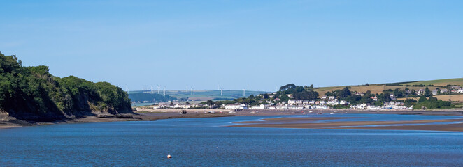 Fototapeta premium Landscape view of the scenic tourist town of Instow in north Devon. Viewed from further down the Torridge estuary, at high tide.