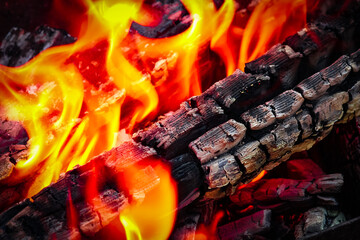 A Fire with coals and fire on nature picnic background. Burns out a bonfire for food on the street