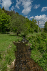 Assky creek near Podhradi village in valley with fresh spring forest