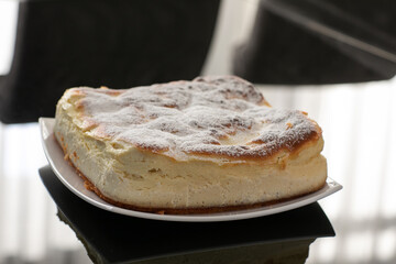 Fresh home cottage cheese pie on black mirror table