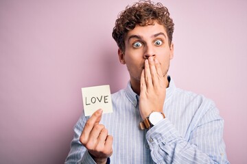Young blond romantic man with curly hair holdiing paper with love message for valentines day cover...