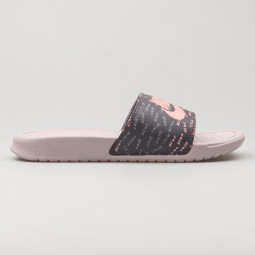 VIENNA, AUSTRIA - FEBRUARY 19, 2018: Nike Benassi JDI Print grey and pink sandal on white background.