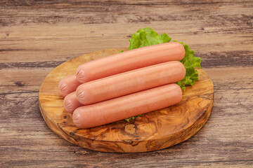 Tasty meat sausages over board