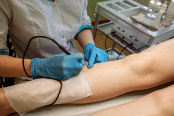 Beautician is doing hair removal to the patient,electro epilation process.