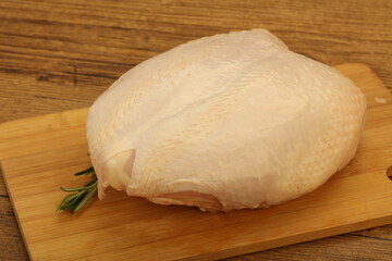 Raw whole chicken breast with skin