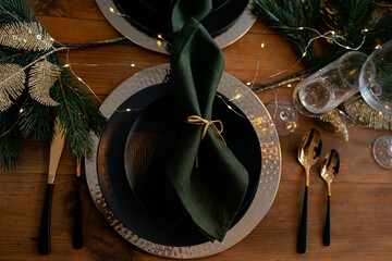 christmas still life. wooden table with green napkins and ceramic dishes