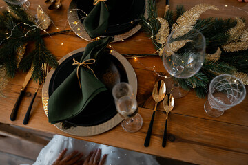 christmas still life. wooden table with green napkins and ceramic dishes