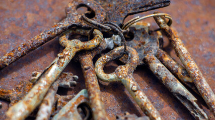 Bunch antique keys on metal table. Close up.
