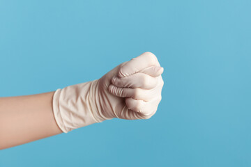 Profile side view closeup of human hand in white surgical gloves showing gesture. indoor, studio...