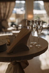 table setting in restaurant. glasses with champagne. beautiful minimalist interior