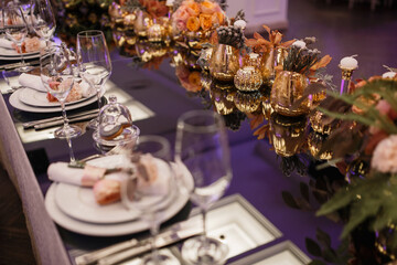 wedding table setting. flowers and candles in a beautiful restaurant. view from above