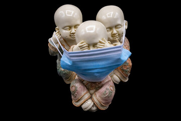 The three wise Buddha "see no evil, hear no evil, speak no evil" like The three wise monkeys with hygienic and surgical masks, antivirus masks to protect yourself from the covid 19 coronavirus