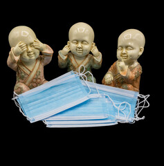 The three wise Buddha "see no evil, hear no evil, speak no evil" like The three wise monkeys with hygienic and surgical masks, antivirus masks to protect yourself from the covid 19 coronavirus