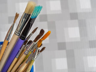 Natural art brushes and bristle brushes in the stand. Set of art brushes for painting with oil,...