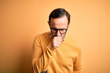 Middle age hoary man wearing casual sweater and glasses over isolated yellow background feeling...