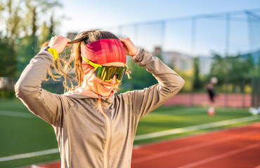 Woman jogging workout training. Athletic girl running on Red running track in the stadium.