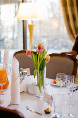 A bouquet of tulips on a table in the restaurant
