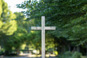 metal cross at the entrance of a cemetery