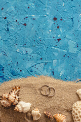 Obraz na płótnie Canvas beach seashells and wedding engagement rings