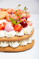 Homemade numbers cake with white cream strawberries and cherries