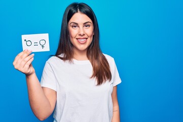 Beautiful woman asking for sex discrimination holding paper with gender equality concept looking...