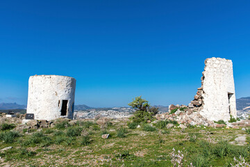 Fototapeta na wymiar old windmills located in the bodrum of the high hill in Turkey.