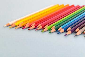 a selection of colourful sharpened pencil lined up on a table
