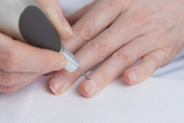 Home manicure. The care and treatment of the nails using a special apparatus. Self-care for nails, quarantine during the pandemic.
