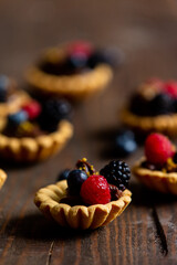 tartlets with berries and chocolate cream on a table
