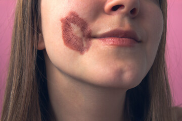 portrait of a woman with a kiss on the cheek on the embankment by the river in winter