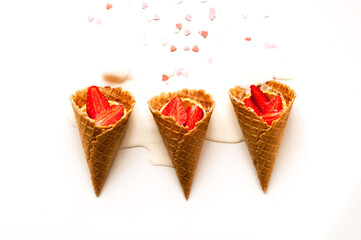 Melting ice cream in waffle cones with strawberries on white background. National ice cream day 19 july concept. Close-up