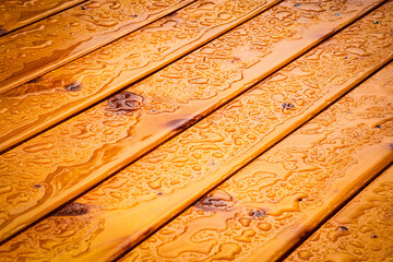 slant wooden table top with water drops
