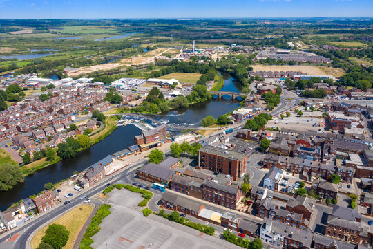 Aerial photo of the village centre of Castleford in Wakefield, West Yorkshire, England showing the main street along side the River Aire on a bright sunny summers day
